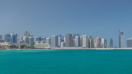 Fototapeta premium Nowoczesne budynki w Abu Dhabi panoramę timelapse z centrum handlowym i plażą.
