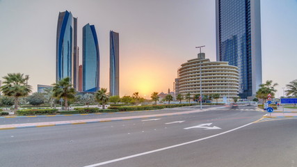 Fototapeta na wymiar Skyscrapers of Abu Dhabi at sunset with Etihad Towers buildings timelapse.