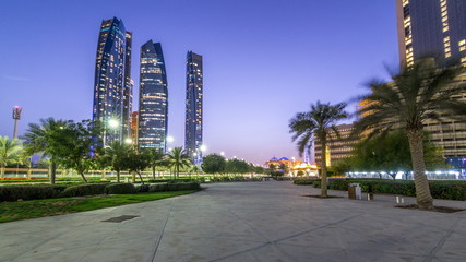 Skyscrapers of Abu Dhabi with Etihad Towers buildings day to night timelapse.