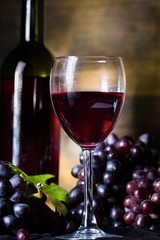 Wine Glass, Wine Bottle And Red Grape Clusters Close-up