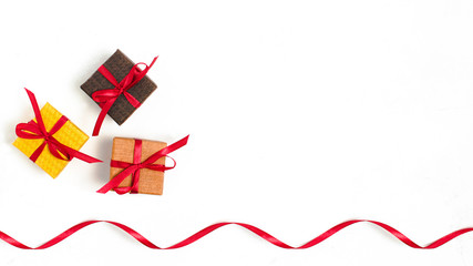 Cute square present boxes with red ribbon.