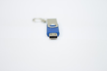 Blue usb flash drive for saving information on a white background close-up