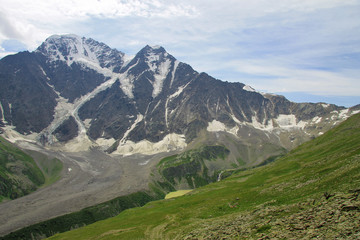 Multicolored lake between mountains of Northern Caucasus