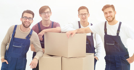 Men holding pile of carton boxes isolated on white background