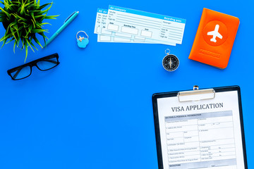 Preparing to travel. Legalize papers. Visa application form near passport and airplane ticket on...
