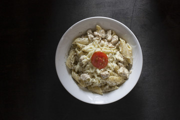 penne pasta on dark background