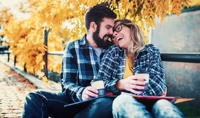 Student's love. Couple of students with a books in the park. Education, love and tenderness, dating, romance, lifestyle concept