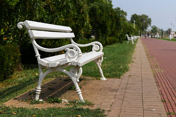 White benches along the lane