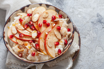 Coconut rice with pomegranate, pear and almond slices