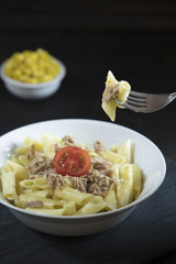 penne pasta on dark background
