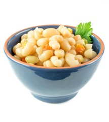 A bowl of white beans and carrot stew on a white background