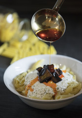 penne pasta on dark background