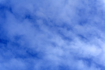celestial background - blue day sky with white cirro-cumulus clouds..