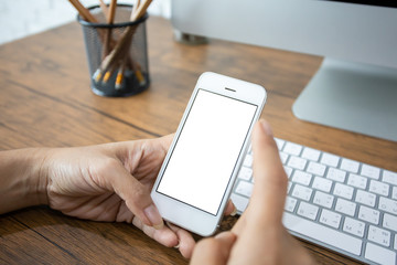 hand woman using a telephone, empty screen smart phone and computer on wooden table In home office. with clipping path