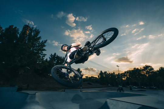 Young man riding BMX on springboard