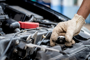 Car mechanic are opening the radiator cap. Check to see if the water level reaches the threshold or...