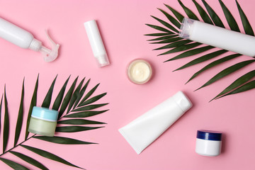 natural cosmetics and green leaf on a colored background top view. flatlay 