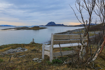 Fototapeta na wymiar Bench by the sea in Bronnoy Northern Norway