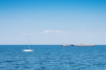 Pleasure yacht and merchant ships in the Black Sea
