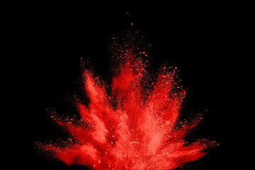 Explosion of coloured powder isolated on black background