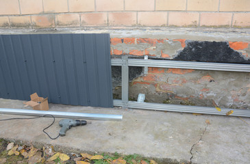 House foundation wall repair and renovation  with installing metal sheets for waterproofing and protect from rain.