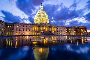The US Capitol in Washington DC at nightfall with dramatic clouds
