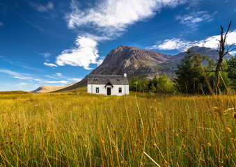 The remote Lagangarbh Hut in front of Buachaille Etive Mor in Glen Coe on a beautiful summer afternoon, Scotland