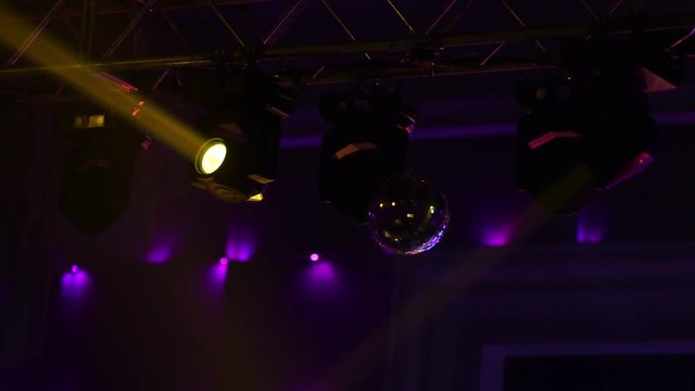 Light equipment with searchlight work on frame above stage