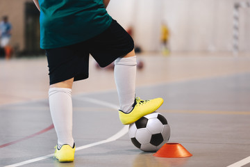 Indoor soccer player training with balls. Indoor soccer sports hall. Football futsal player, ball,...