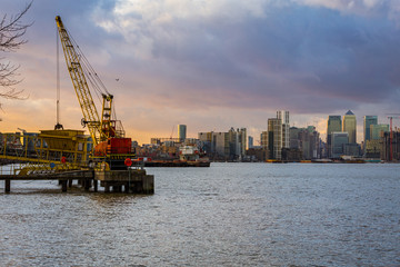 Crane on Thames with Canary Wharf in the distance