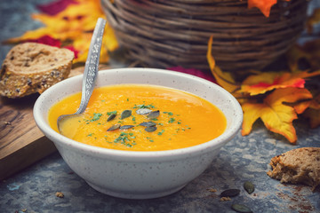 Homemade pumpkin soup served with parsley and pumpkin seeds