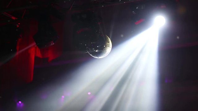 Stage lights. Soffits. Concert light. Silver mirror disco ball in the rays of the spotlights