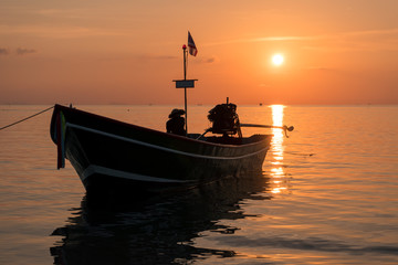 Sunset with silhouette of Traditional Longtail boat in the sea. Thailand
