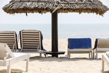 Deck chairs and shade at sunny beach