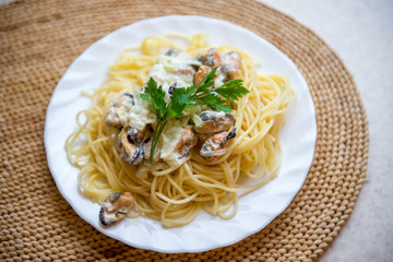 Traditional italian seafood pasta with clams. Spaghetti with mussels in creamy sauce