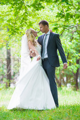 Wedding. Happy bride and groom in park