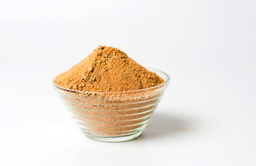 Cacao powder in a bowl on white
