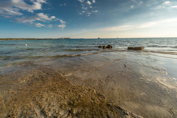 Beautiful sun reflections, late afternoon scene in Es Trenc beach. Majorca Island, Spain