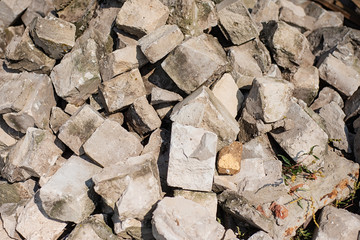 pile of old white broken bricks on the street. Stone texture for use