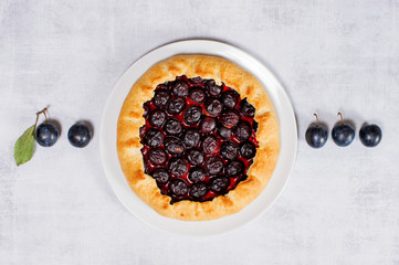 Homemade traditional plum galette on the white plate