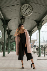 Pretty young girl posing at train station