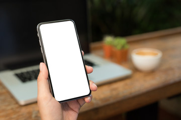 Man showing of blank screen smartphone while working