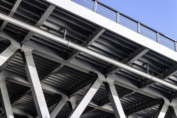 Gray metal framework of the bridge. Industrial construction