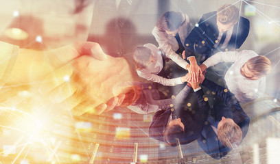 Handshaking business person in office. concept of teamwork and partnership. double exposure with...