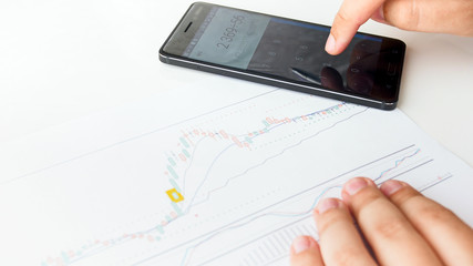 Closeup image of businessman calculating risks using financial activity graph