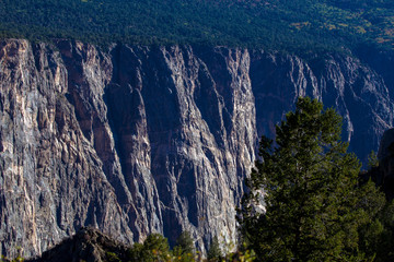 Steep, rocky black cliffs and eroded ridges characterize the landscape of Black Canyon of the Gunnison National Park in Colorado