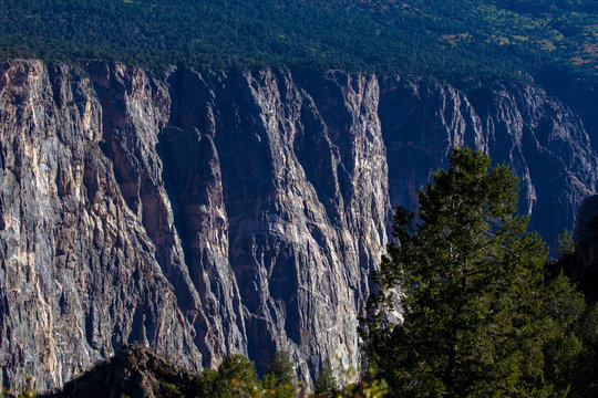 Steep, rocky black cliffs and eroded ridges characterize the landscape of Black Canyon of the Gunnison National Park in Colorado