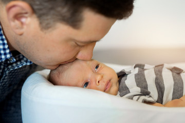 young handsome dad with a young child son at home