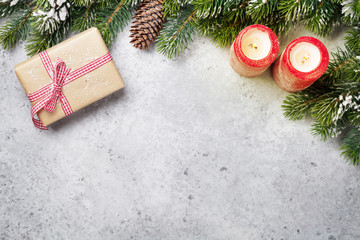 Fototapeta na wymiar Christmas gift box, candles and fir tree branch