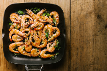 Roasted grilled shrimps on pan on wooden
